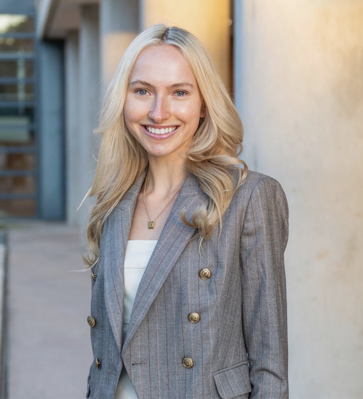 Mary Tish Phillips, smiling, in a gray pinstripe blazer